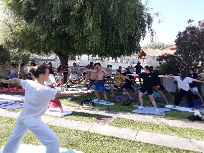 Outdoor yoga session with surf school group under trees — yoga and surf Gaia, Praia da Aguda area